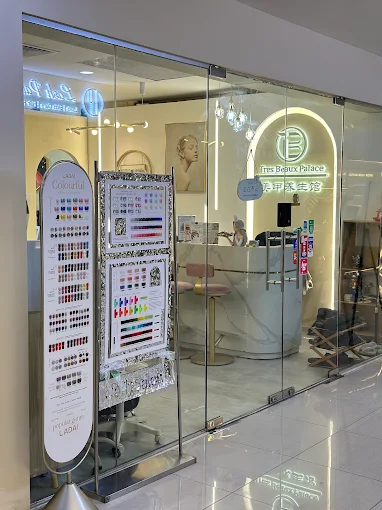 The glass shopfront of Tres Beaux Palace, with the nail colour display standing just inside the doors